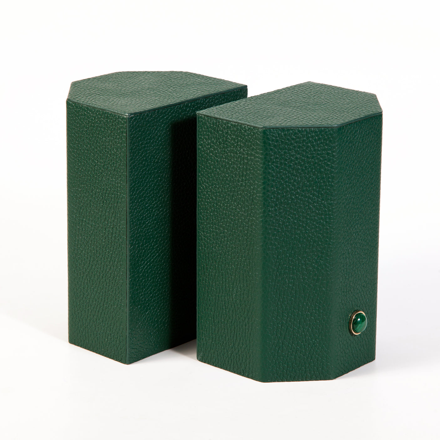 Timeless and tasteful bookends to add color to any library.  Solid geometric blocks of wood covered in leather are the essential jewels on a bookshelf.    Coordinate your bookends to match the decoration of the room.  %100 Leather (Floater leather)   Jeweled with natural malachite stones