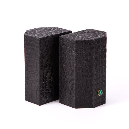 Croco bookends to add style and exotica to any library.  Solid geometric blocks of wood covered in leather are the essential jewels on a bookshelf.  %100 Leather (Embossed Croco)   Jeweled with natural malachite stones