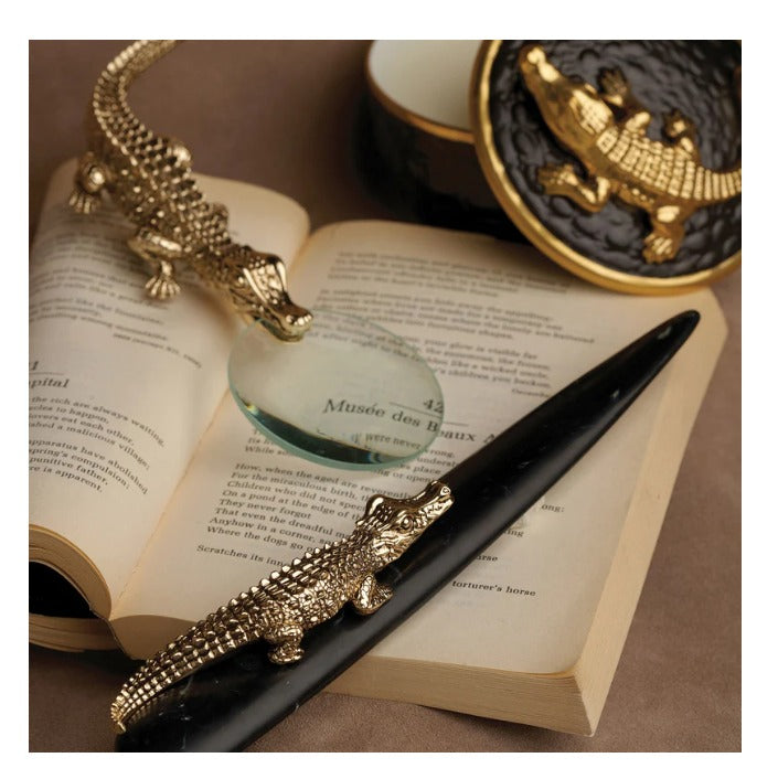 Meticulously handcrafted with 24k gold plating and outfitted with glass with 7x magnification, our Crocodile Letter Opener completes a whimsical desktop collection that is complex in color, rich in texture and global in design L'OBJET 