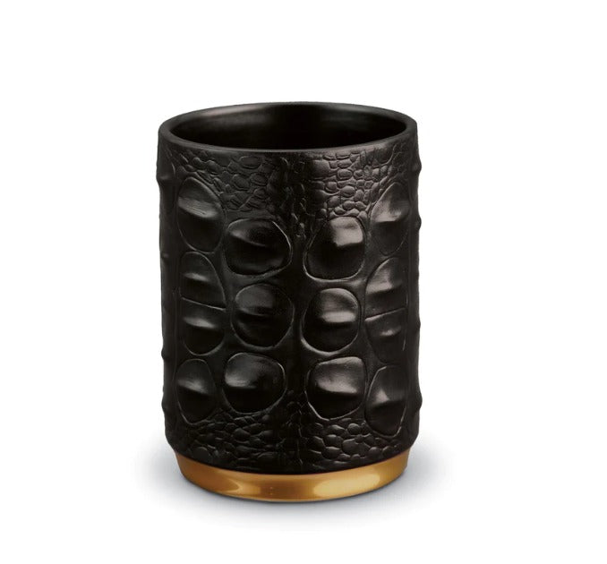 Meticulously handcrafted from porcelain with 24K gold, our Crocodile Pencil Cup completes a whimsical desktop collection that is complex in color, rich in texture and global in design. Also beautifully functional for the bath, vanity, gameroom and other living spaces  3 D x 4 H in (7 D x 10 H cm) Presented in a luxury gift box Fine Porcelain, 24k Gold L'OBJET